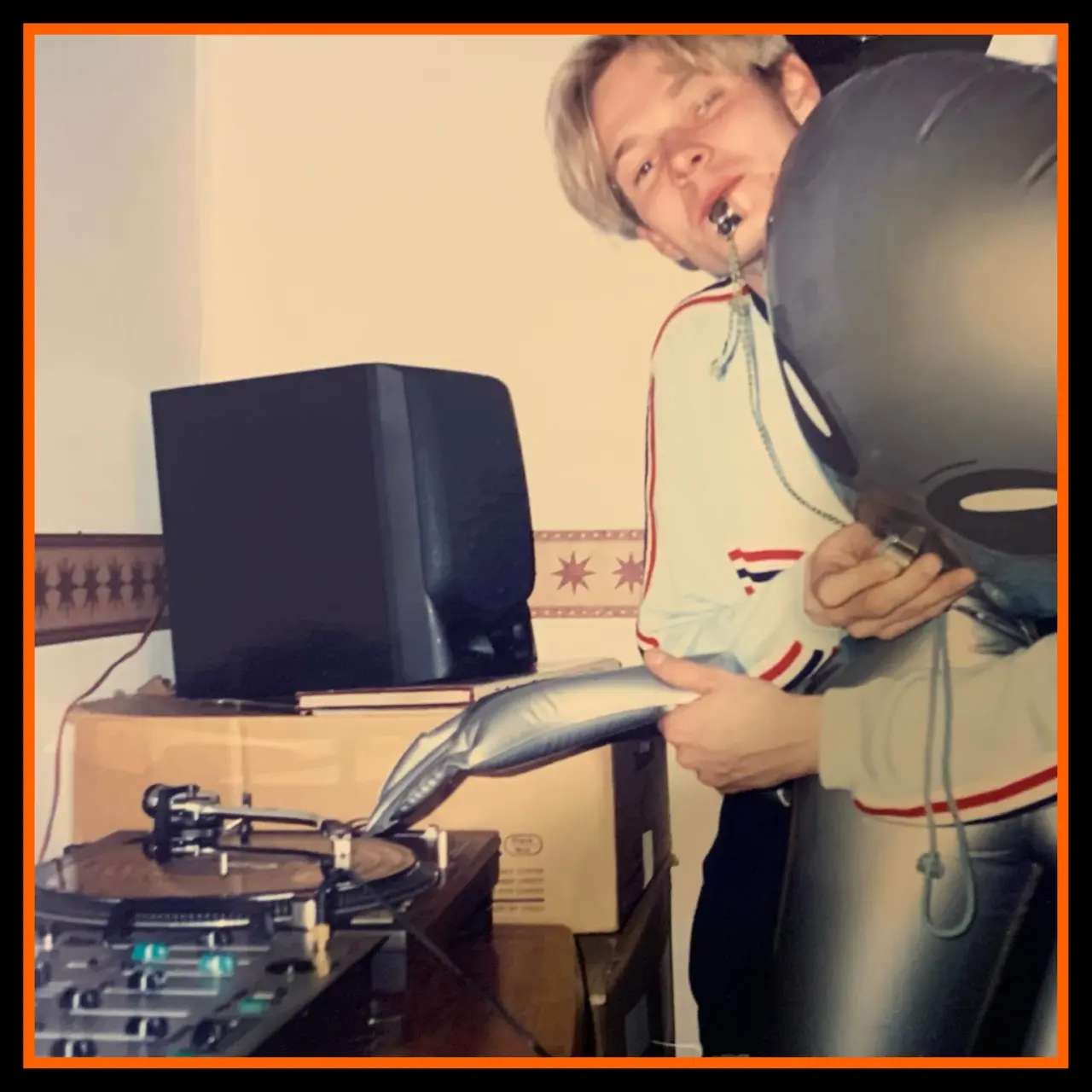 DJ HH at a 90s rave holding an inflatable alien